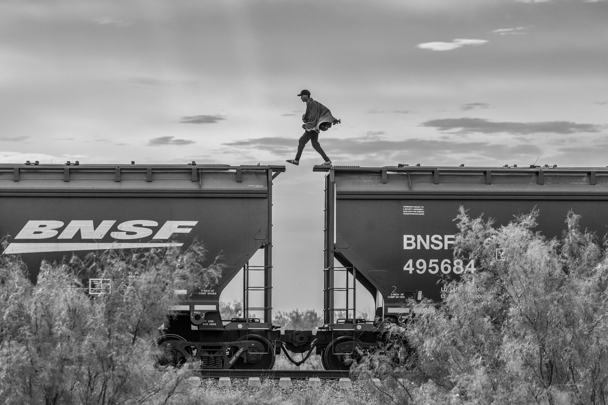 01 Alejandro Cegarra. Mexico, 2023. A man attempts to travel to the United States on a freight train